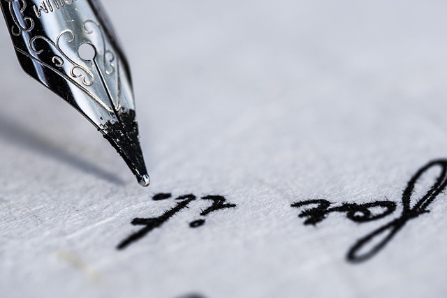 Dip pen writing with visible ink and nib detail
