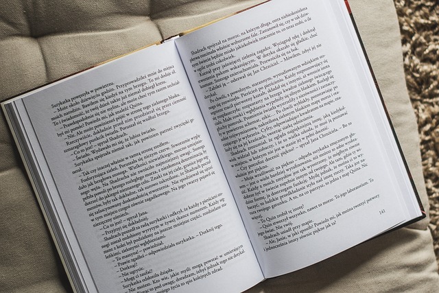 Open book with printed and handwritten text on a reading desk