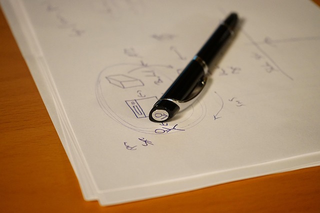 Fountain pen resting on an open notebook with visible ink and handwriting